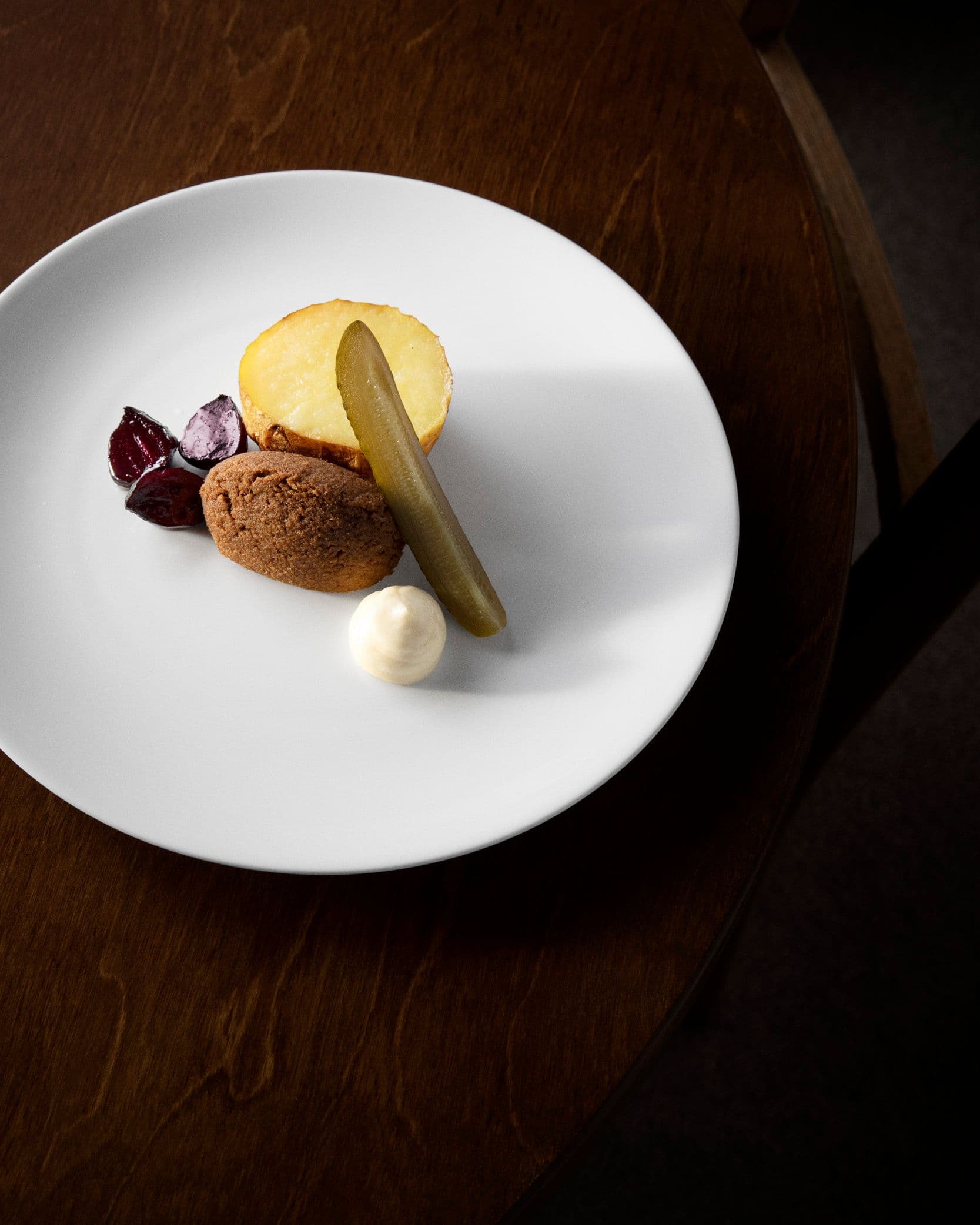 The Savoy vorschmack dish with baked potato, preserved beetroot, pickles and sour cream
